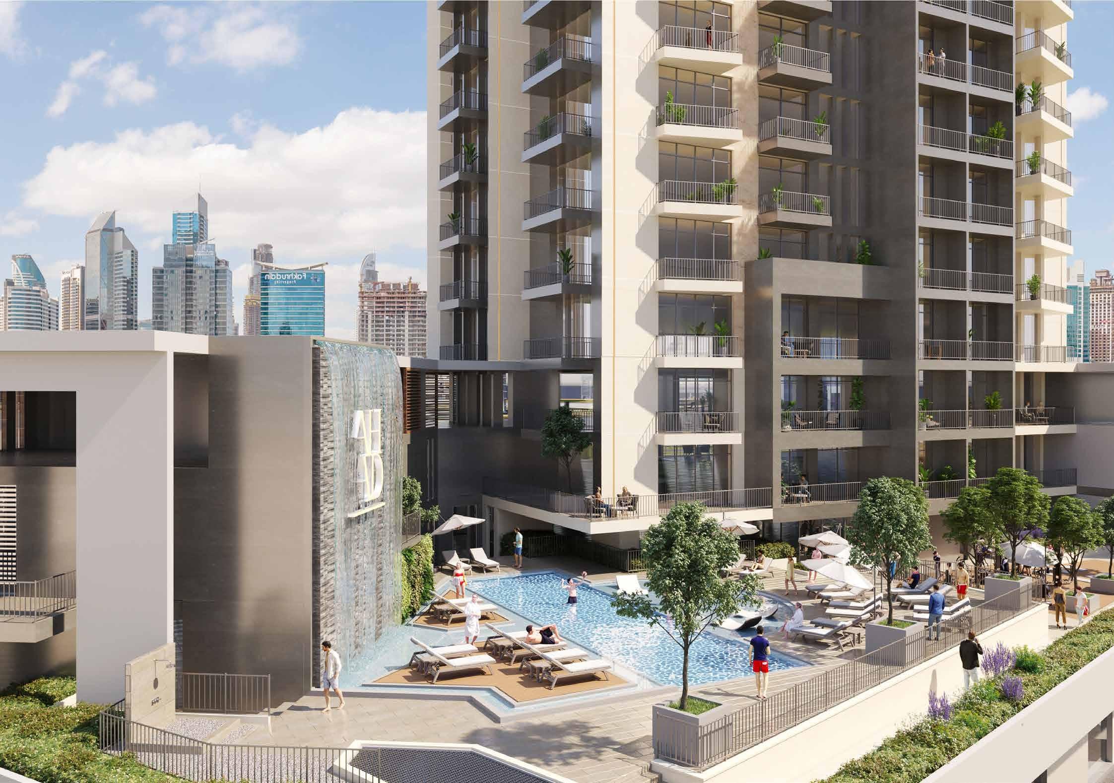 Modern residential building with an outdoor pool and waterfall feature, offering top-tier amenities.