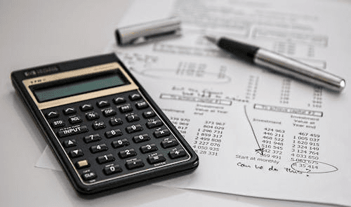 Calculator and financial documents showing bankruptcy filing fees, counseling costs, and extra expenses