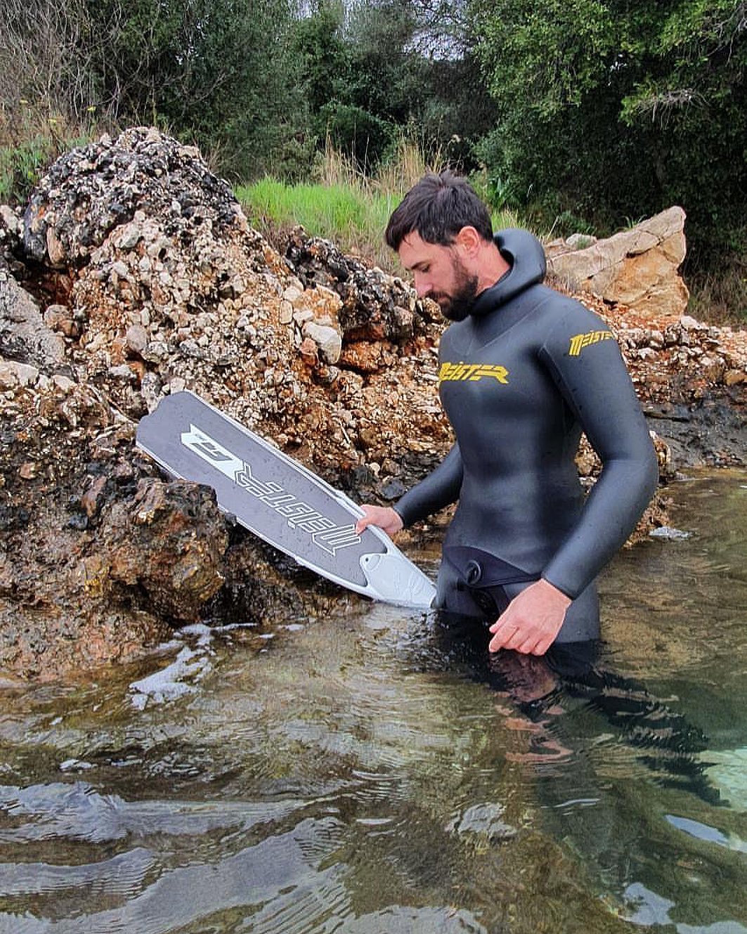 meister athlete diver holding fins