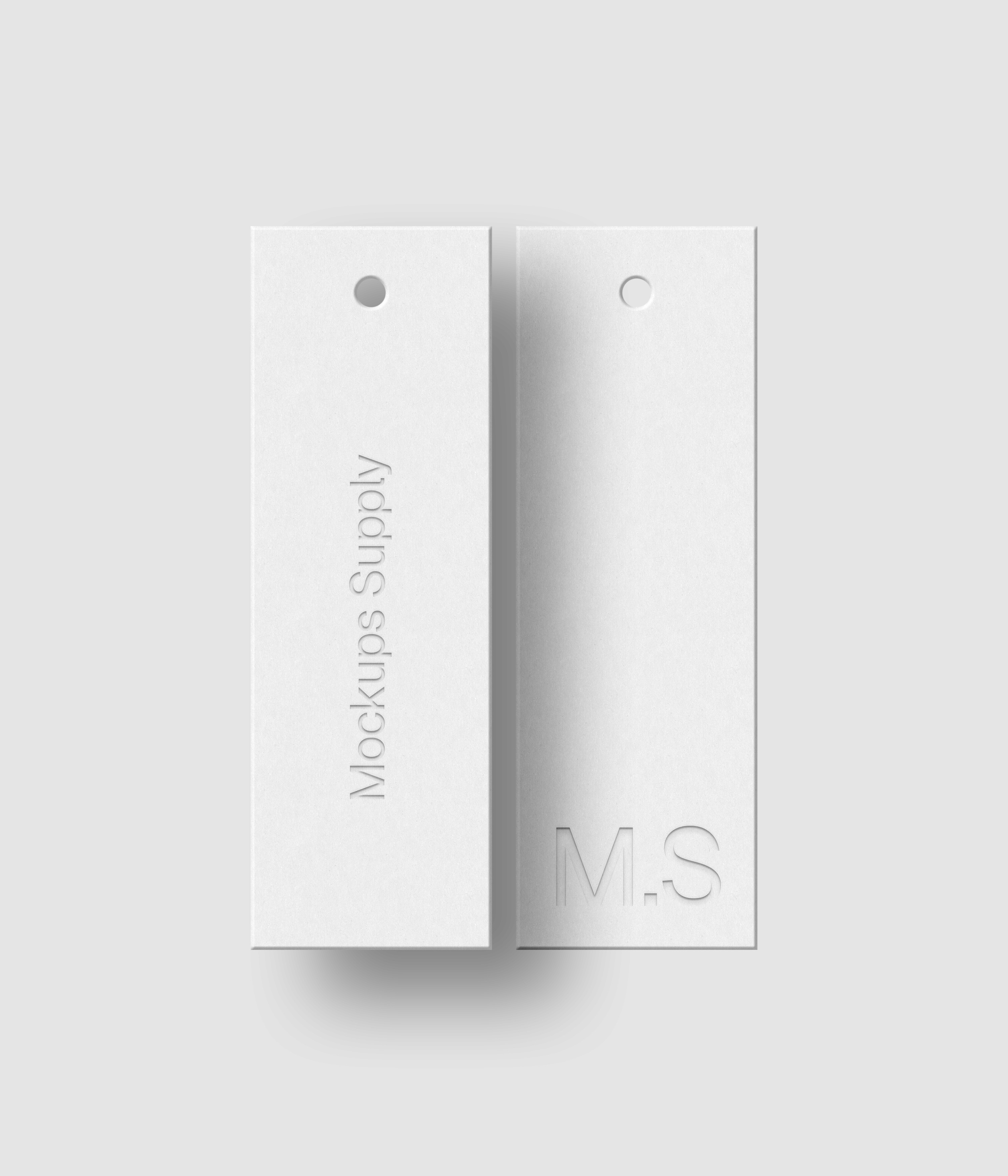Two white 1x3 vertical hang tags mockup on white background with soft shadow and debossed text effect for Photoshop download psd