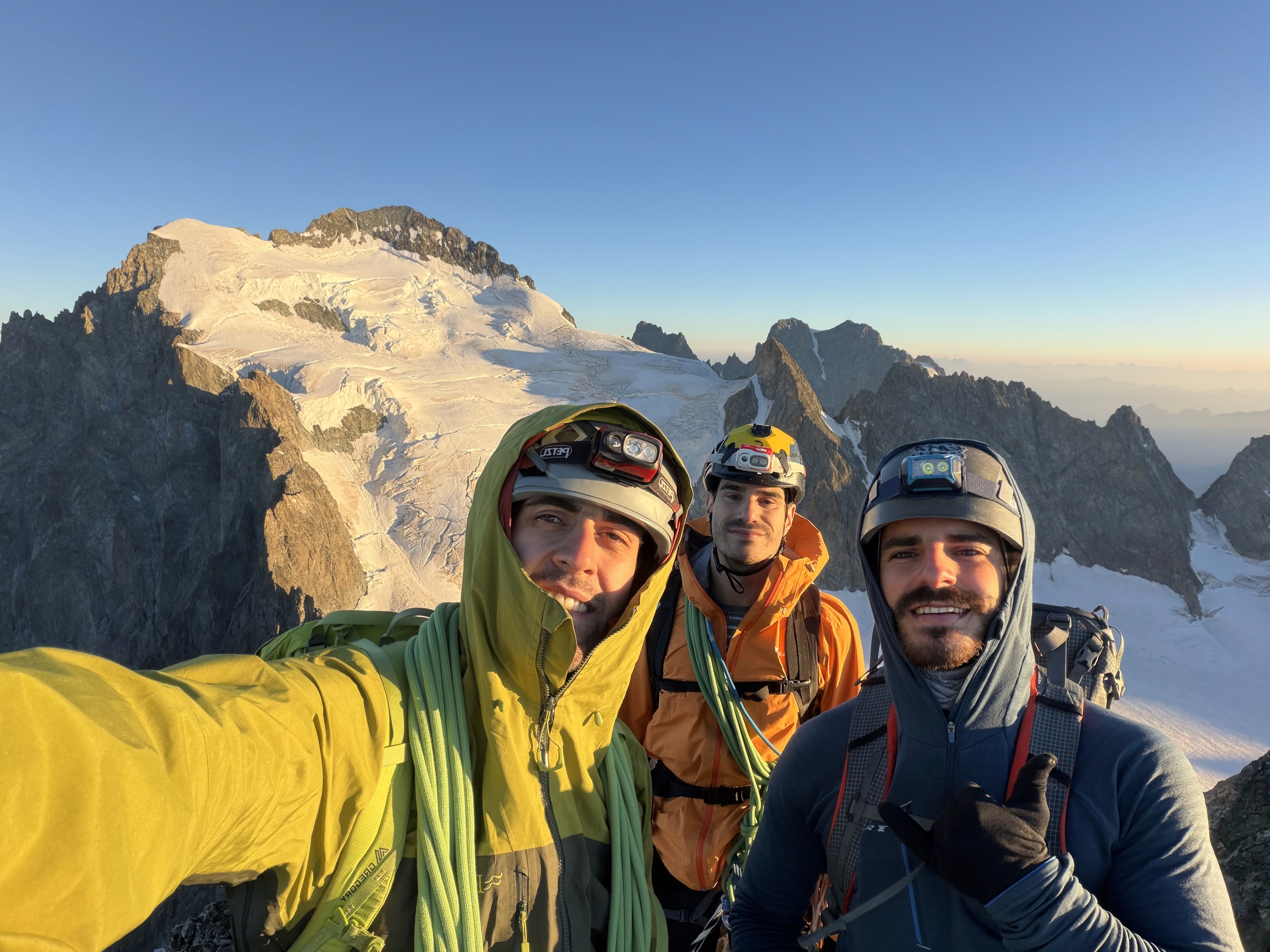 Three climbers on an alpine expedition beneath the Ecrins massif
