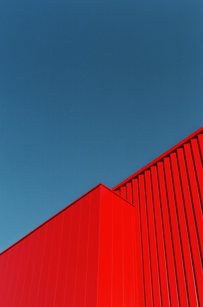 a red building with a blue sky in the background