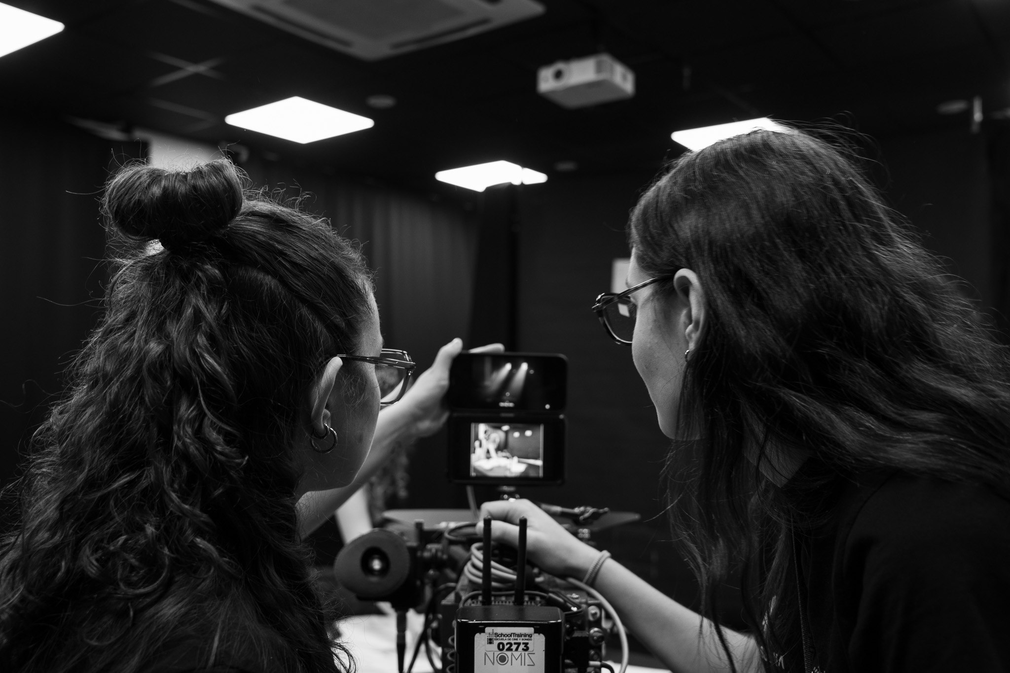 a man holding a camera up to another man