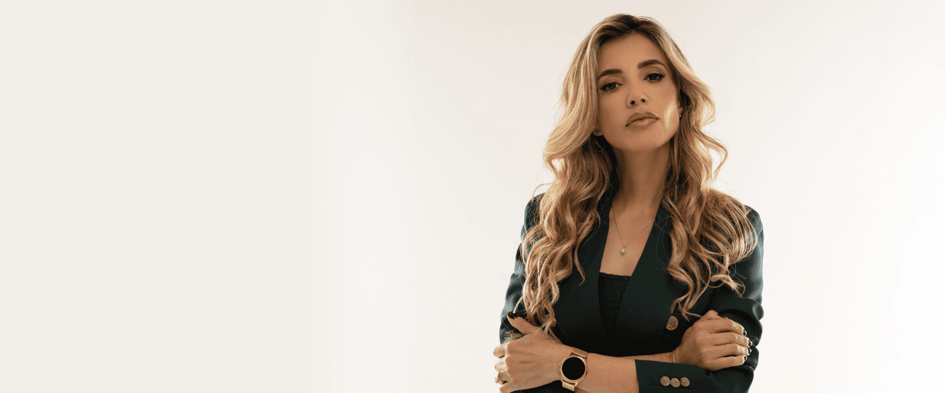 woman in blue tank top standing beside white wall