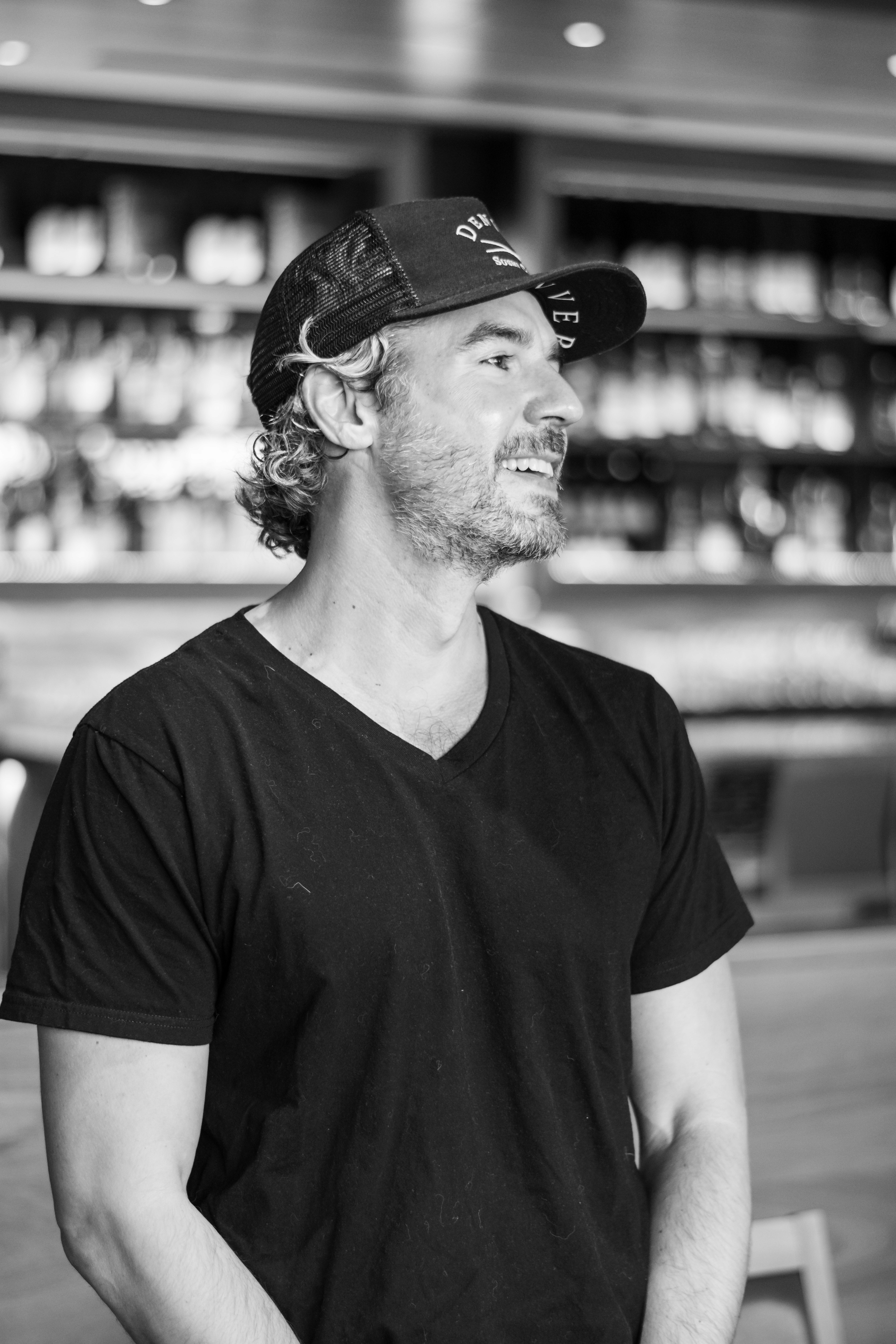 A woman in a straw hat stands in the grass