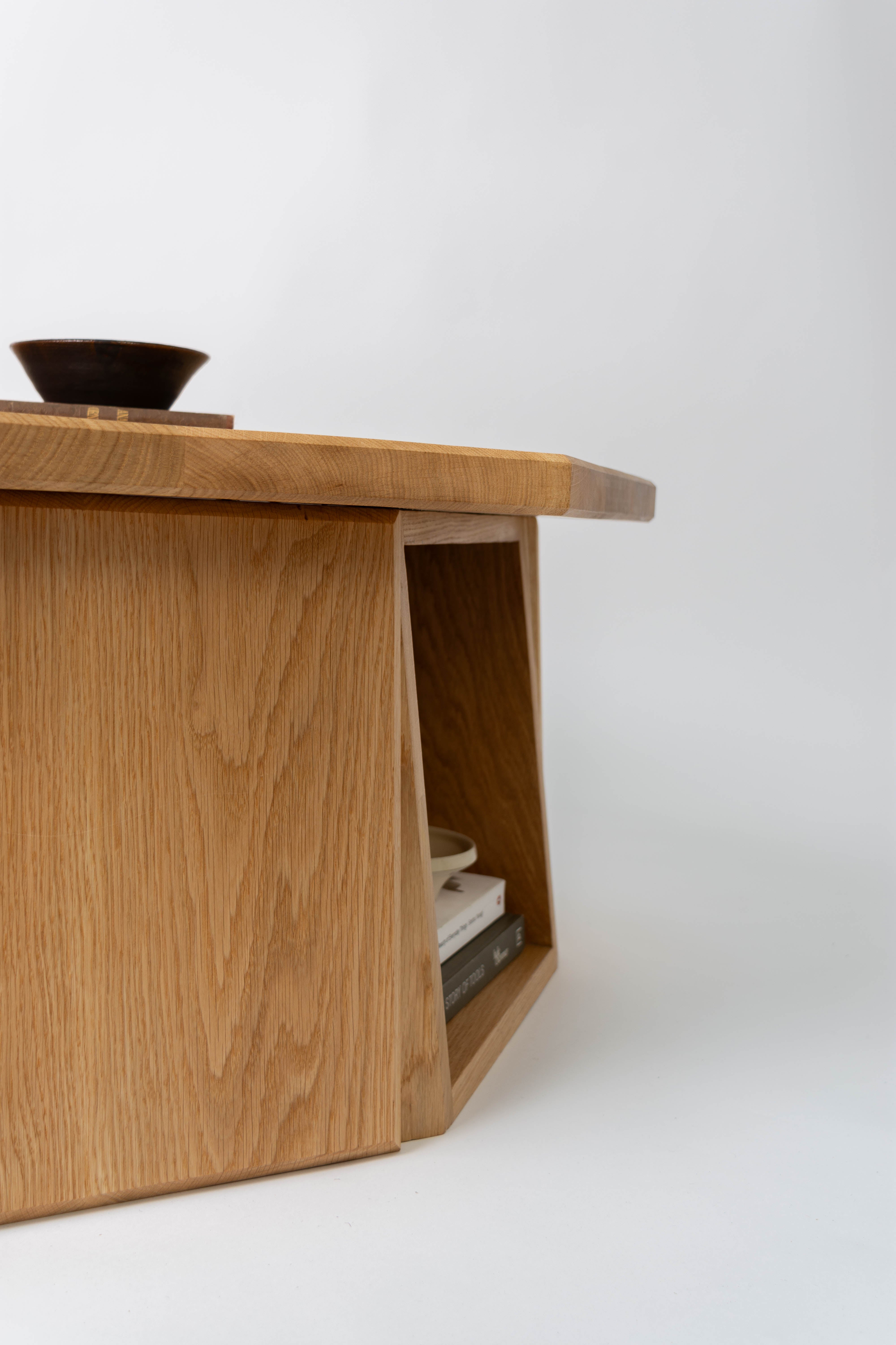 Wooden coffee table with a bowl on top against a white background