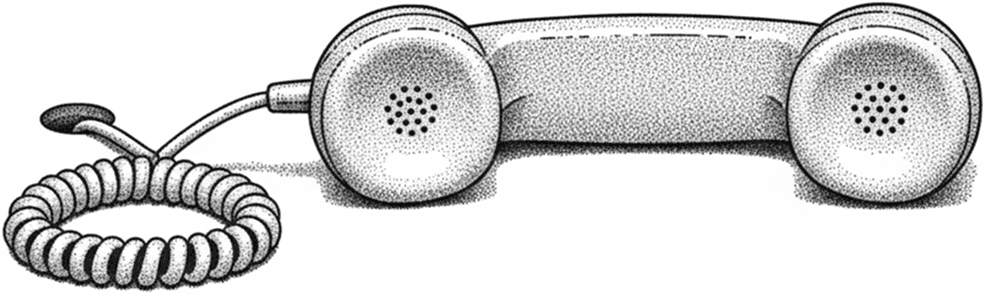 A phone attached to a cord laying on a table