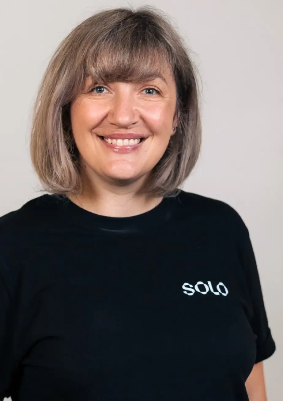 A smiling man in an outdoor landscape