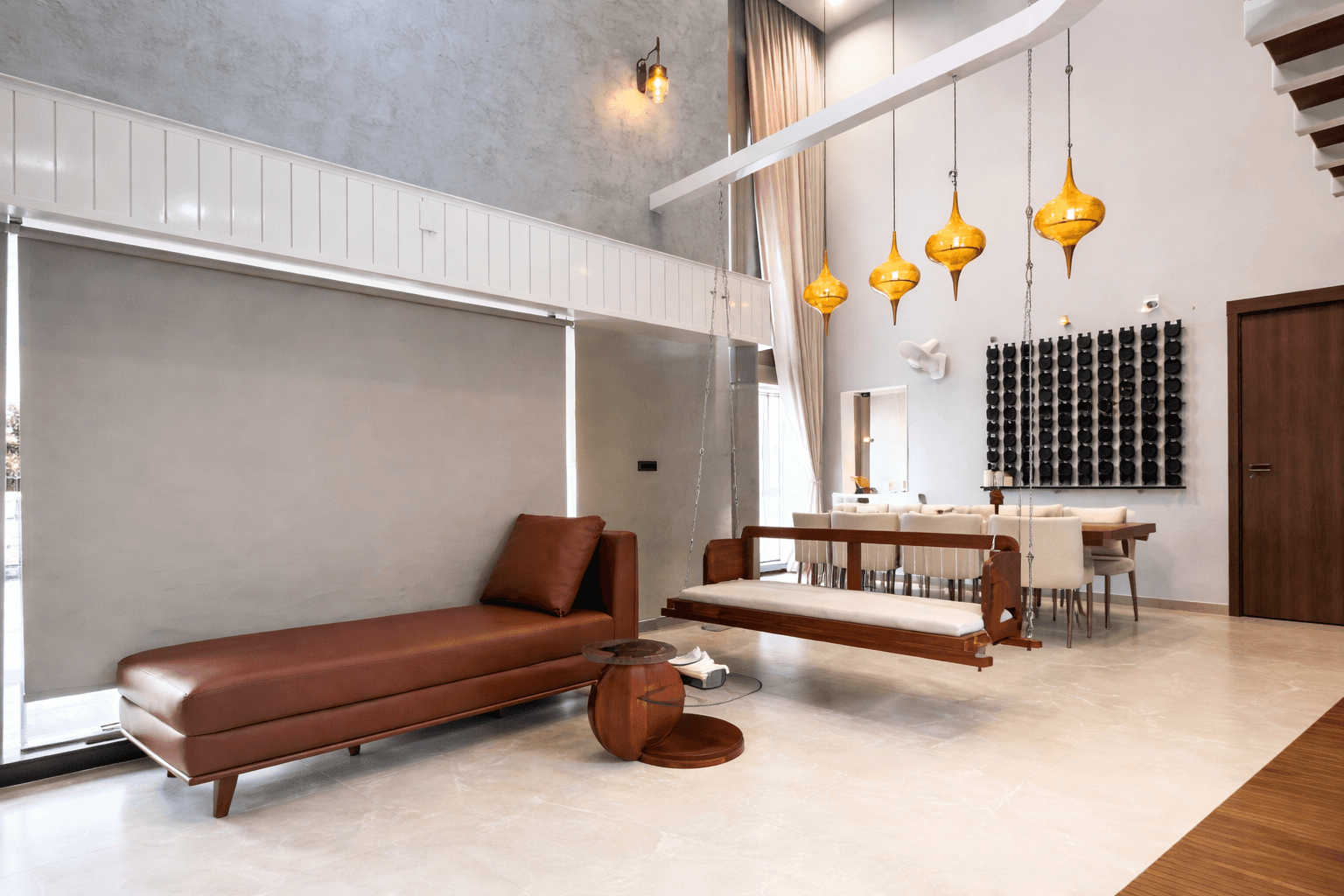 Modern loft interior with greenery, exposed brick walls, large glass windows, and vibrant yellow accents. Inviting atmosphere with natural light.