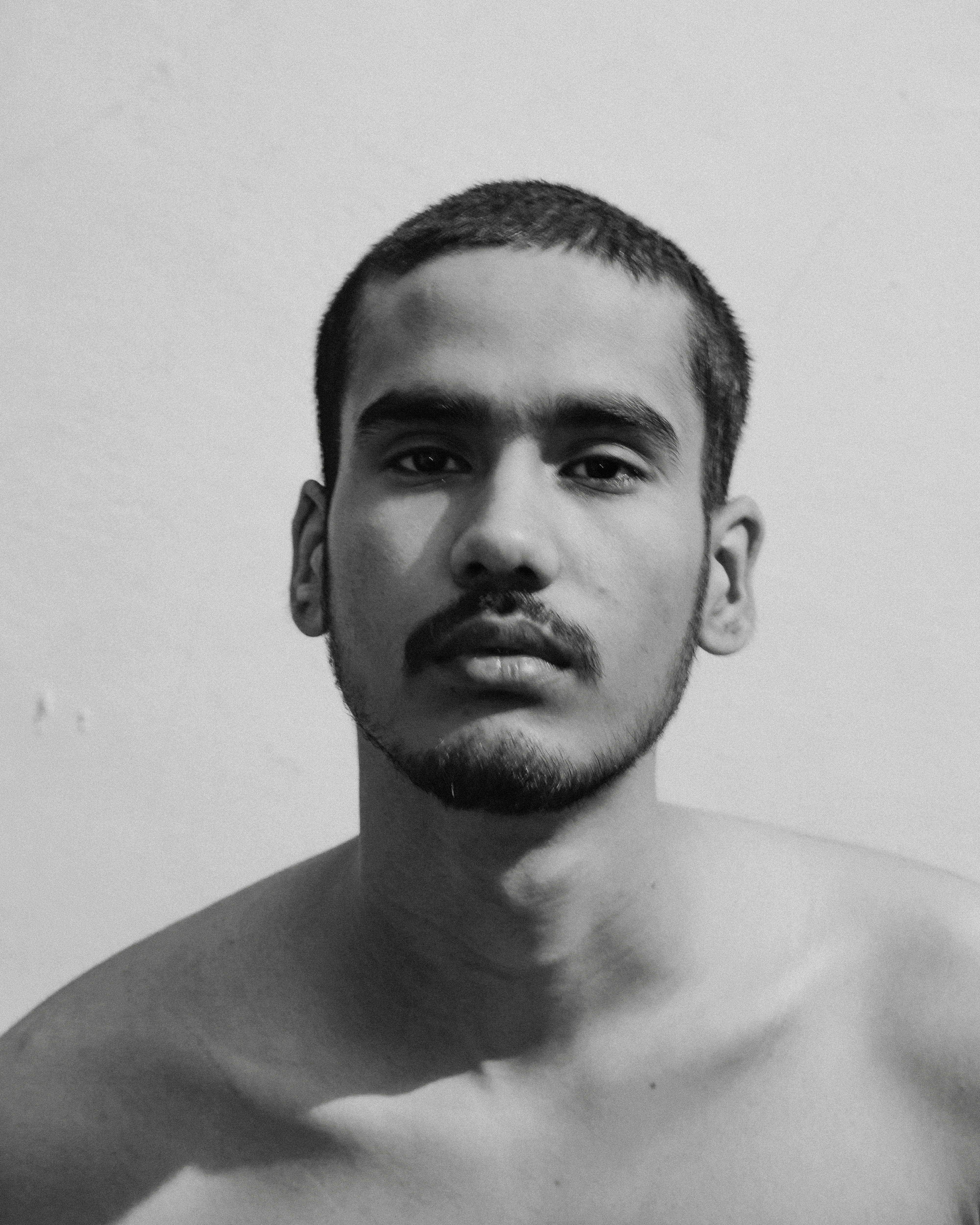 a black and white photo of a shirtless man
