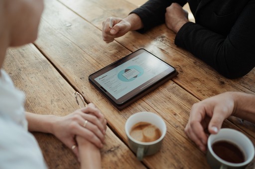 StoryOS strategy session showing a digital narrative blueprint on a tablet during brand clarity discussion