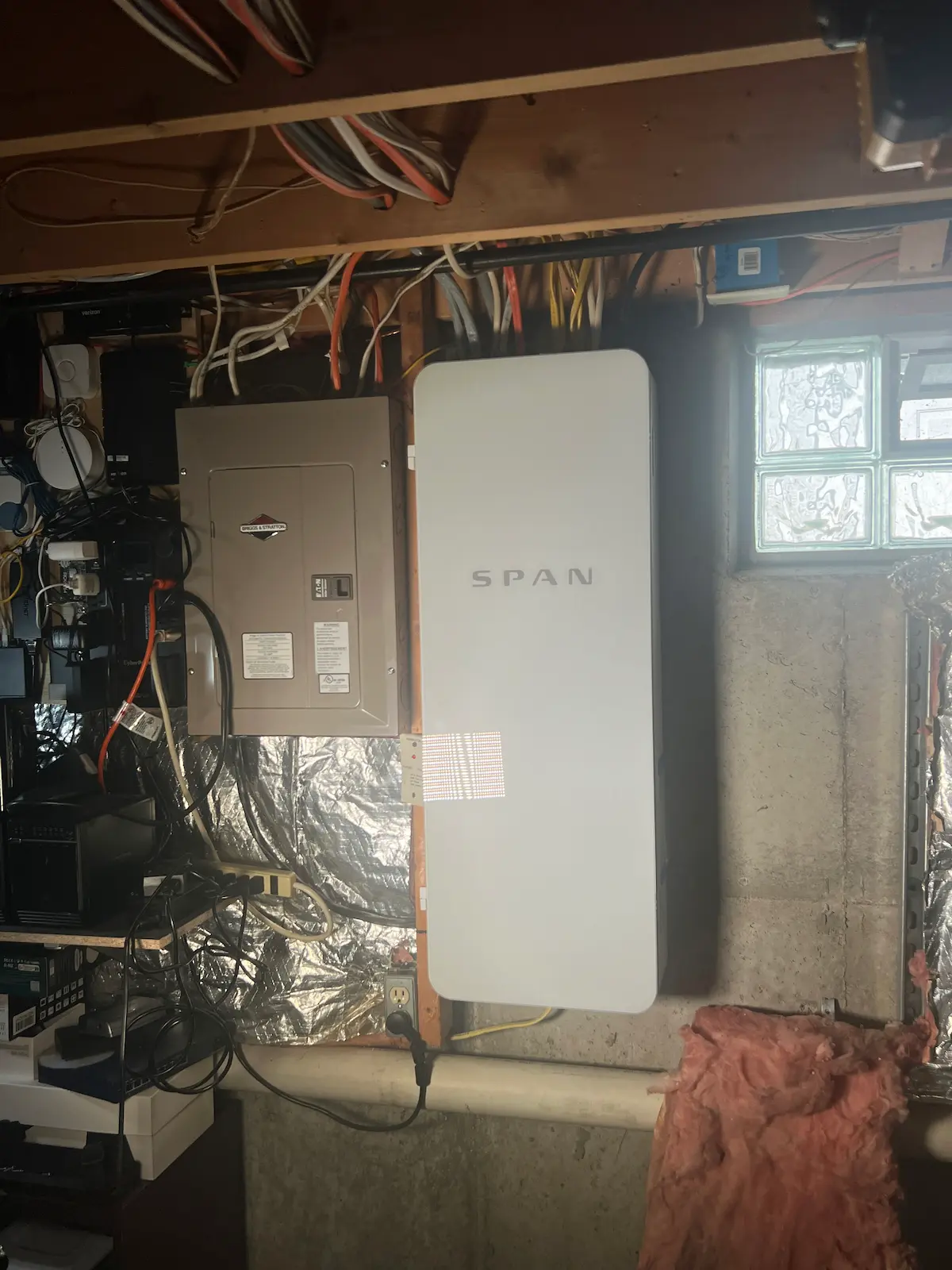 SPAN smart electrical panel installed in a basement with existing breaker panels and wiring.