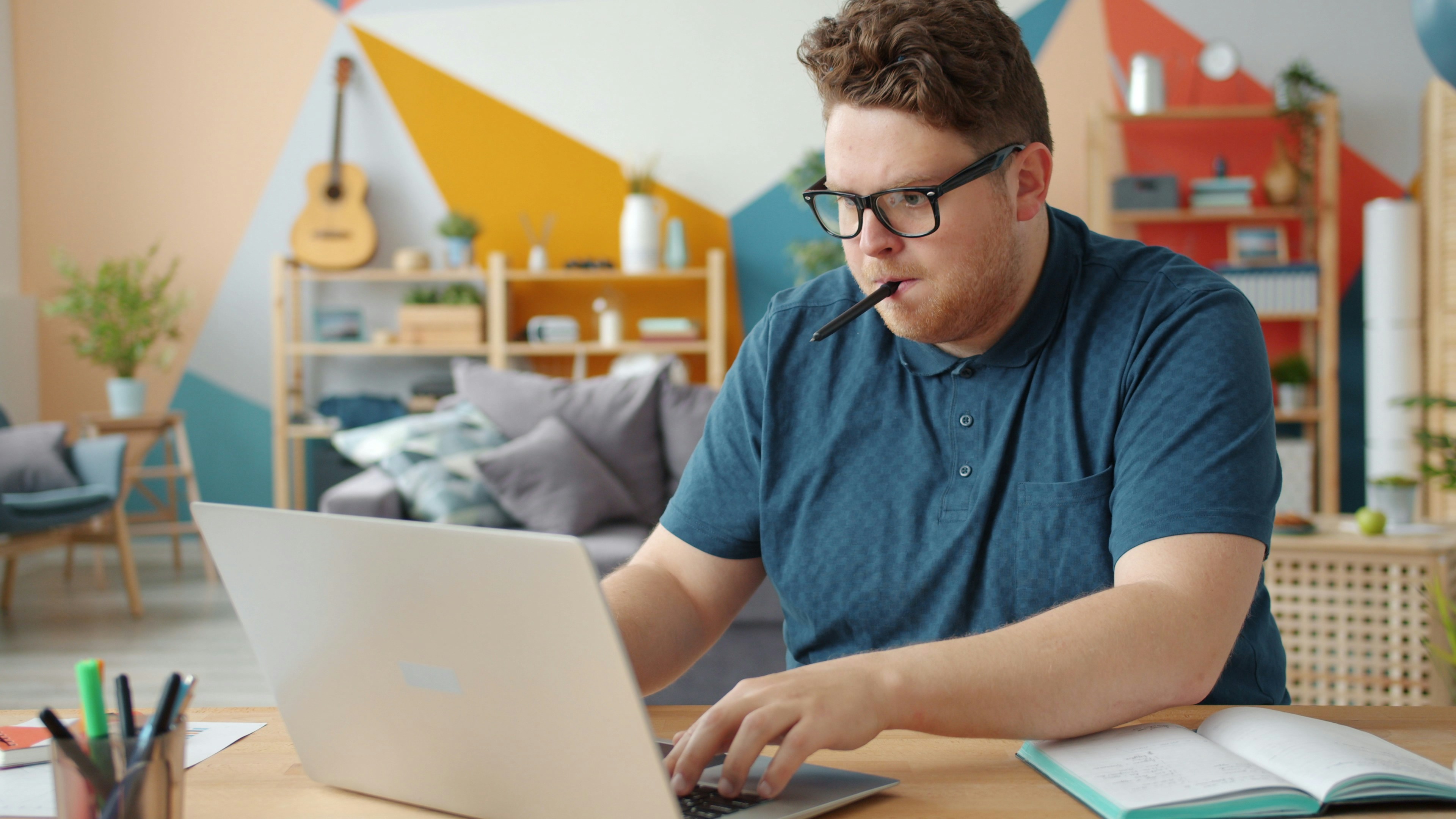 Man working on a laptop at a desk.