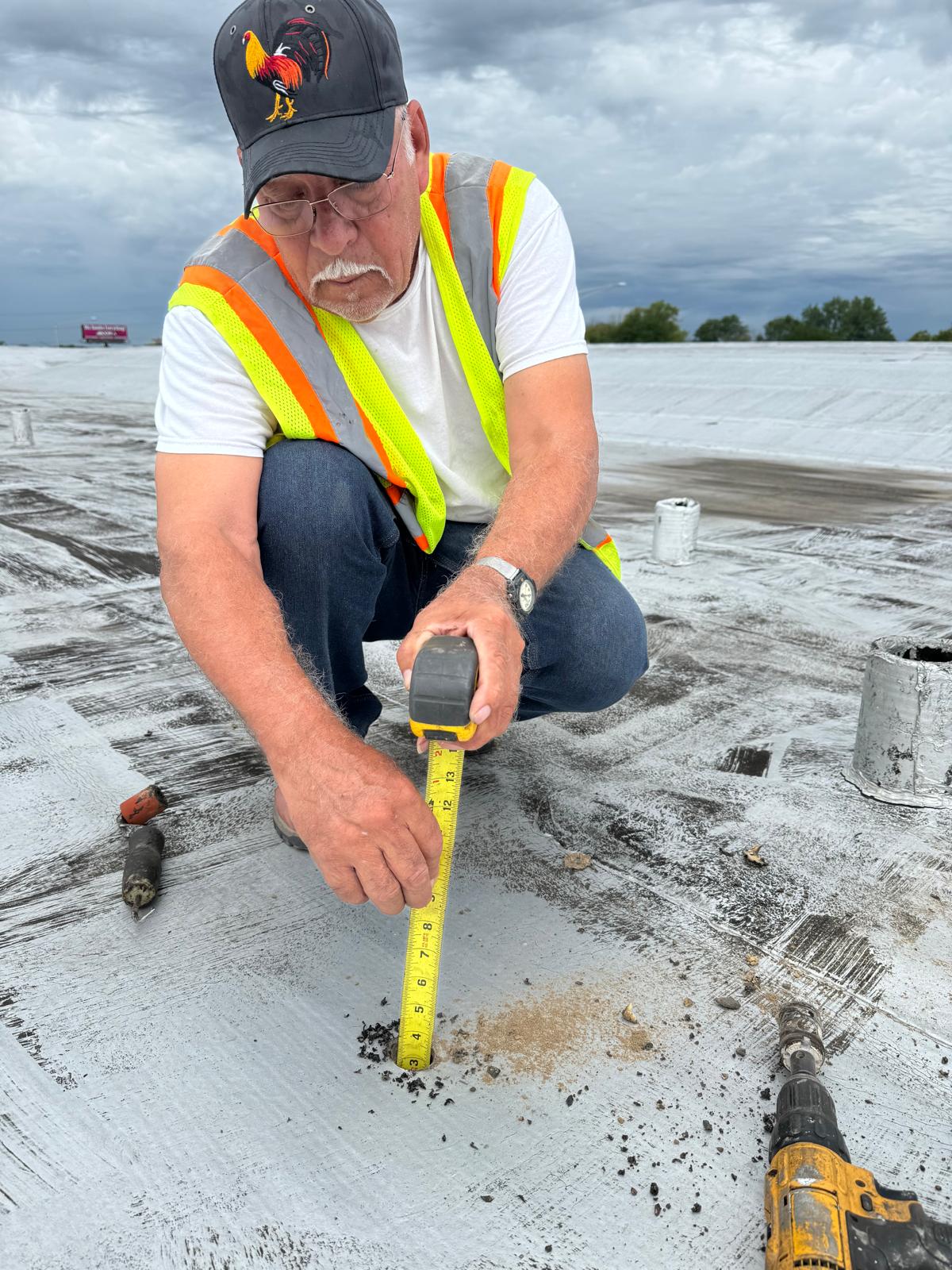 a man in a yellow shirt is working on a roof
