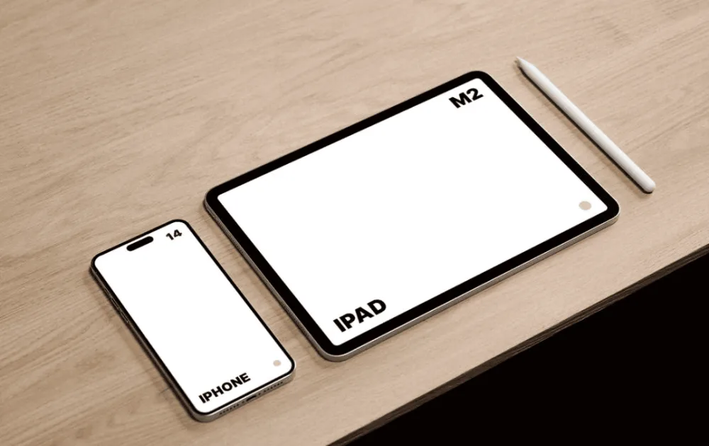 Mockup featuring an iPhone 14 and iPad M2 on a light wooden surface. The iPhone and iPad have blank white screens, with a white stylus positioned beside the iPad for a minimalist setup.