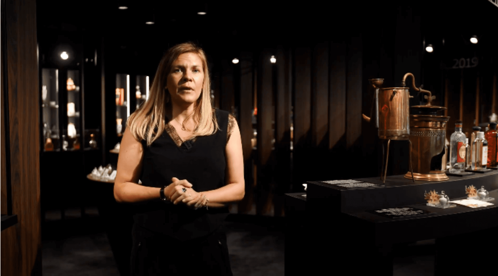 Man in a white shirt reclines in a chair on a red carpet, talking on the phone. Scattered papers surround him, conveying stress or disarray.