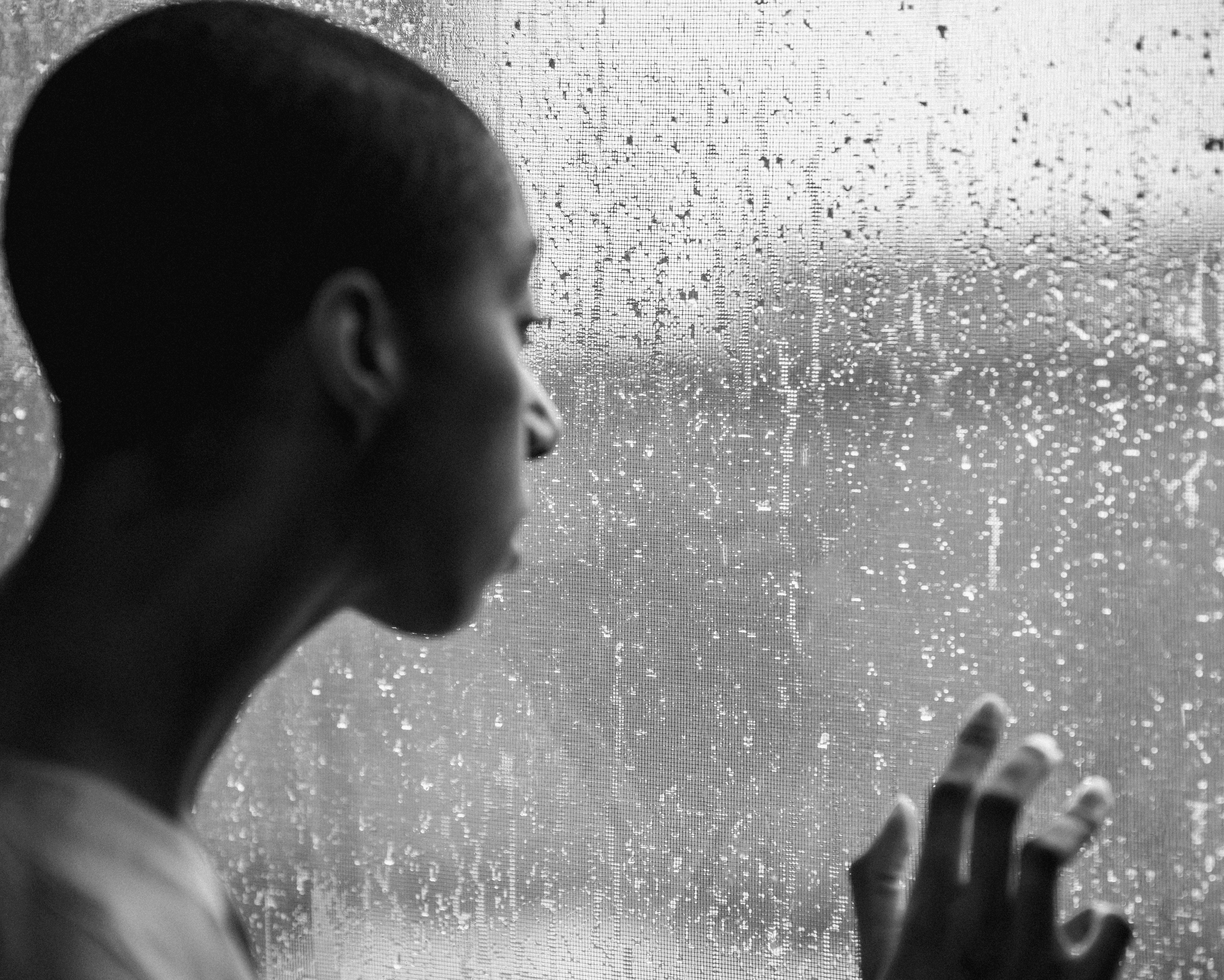 A person walks along a narrow dirt path atop a grassy hill with clear blue skies above, evoking a sense of tranquility and adventure.
