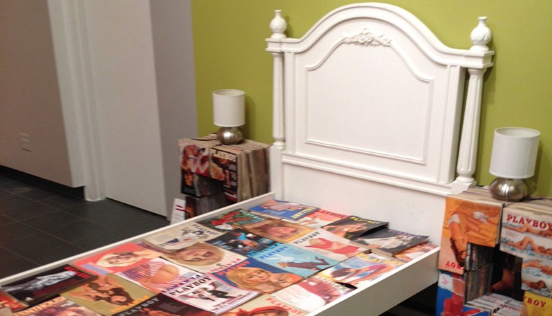 a bed filled with playboy magazine