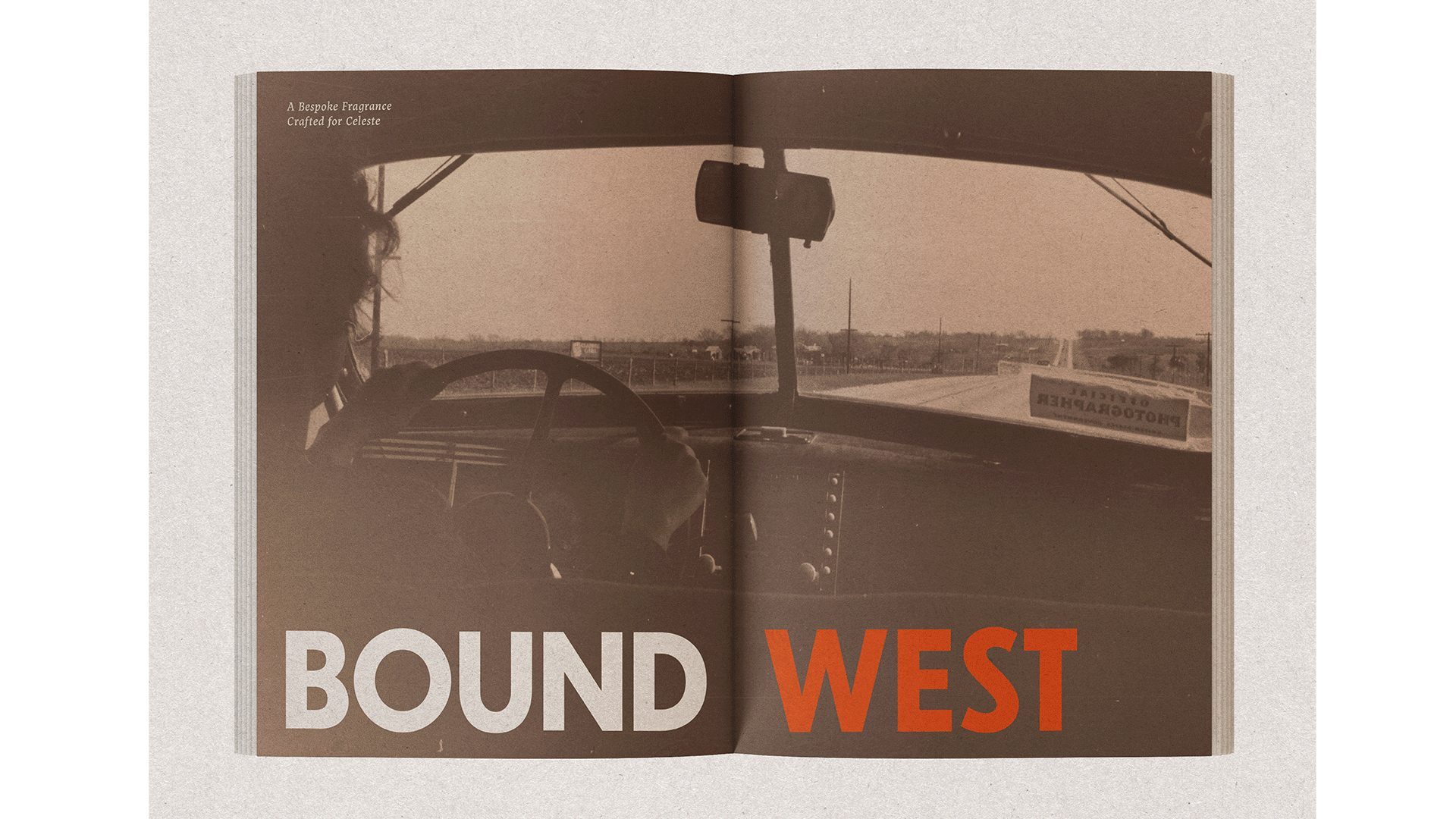 An open book displays a sepia-toned photograph of a car interior, viewed from inside the vehicle. The steering wheel and dashboard are visible, along with a rearview mirror. The background shows a road and distant buildings. The title "BOUND WEST" is printed in white and orange text at the bottom. Above the photograph, smaller text reads "A Bespoke Fragrance Crafted for Celeste."