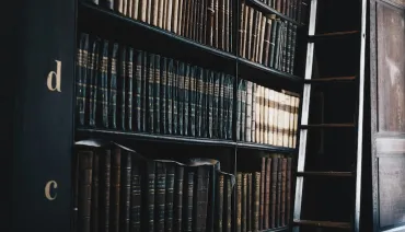 three people sitting in front of table laughing together