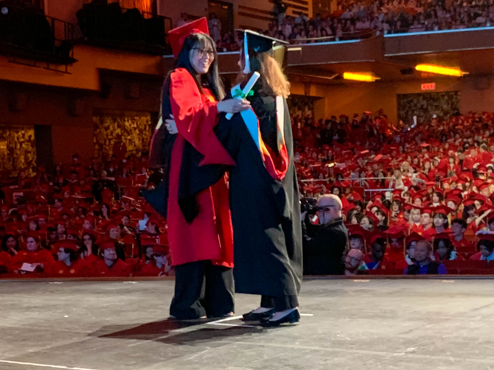 student getting their diploma on stage