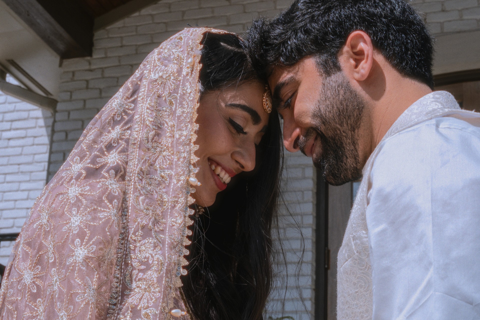Newlyweds smiling at each other