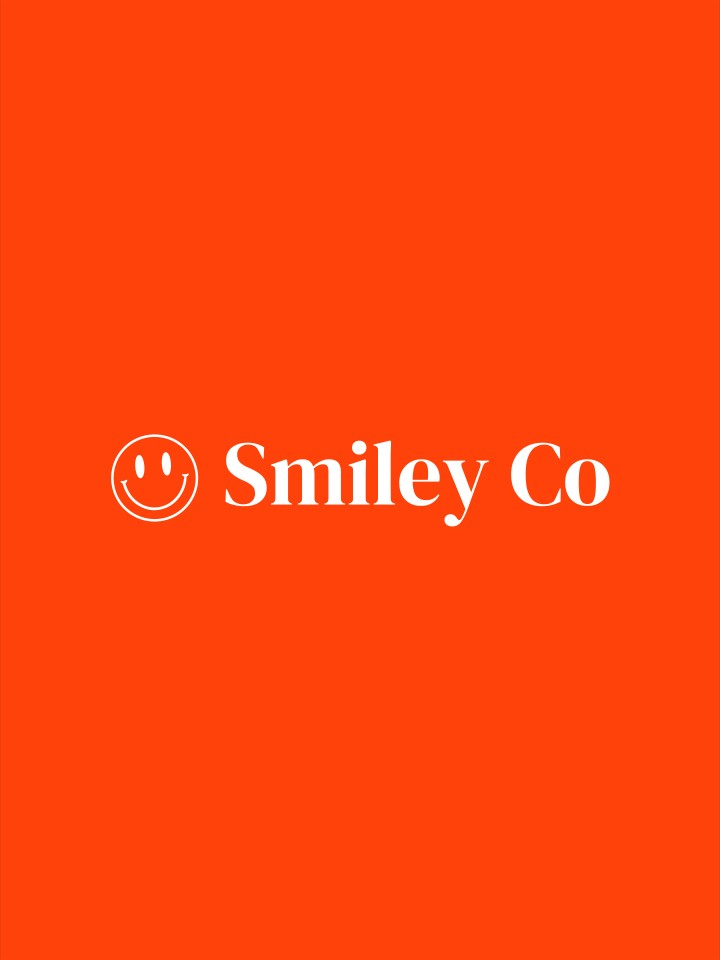 White outline of a classic smiley face followed by the text “Smiley Co” in white serif type on a vivid orange background.