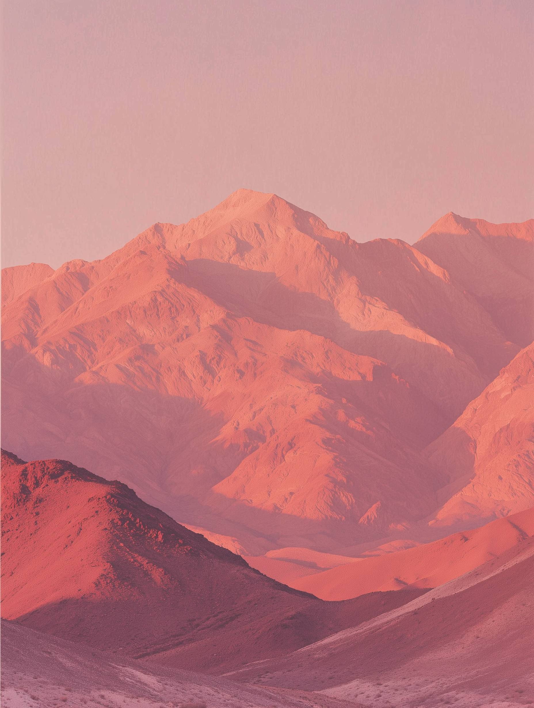 Desert terrain with mountain ranges in sunset colors