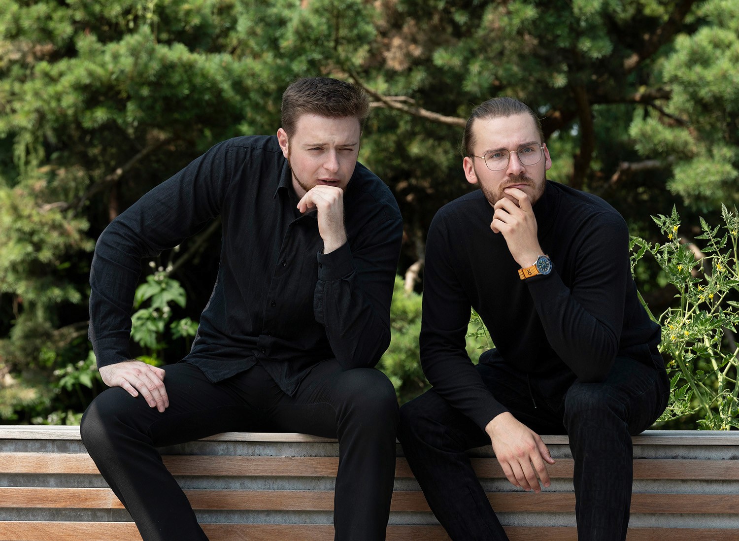 Philip und Johannes Praskac sitzen nachdenkend im Garten.