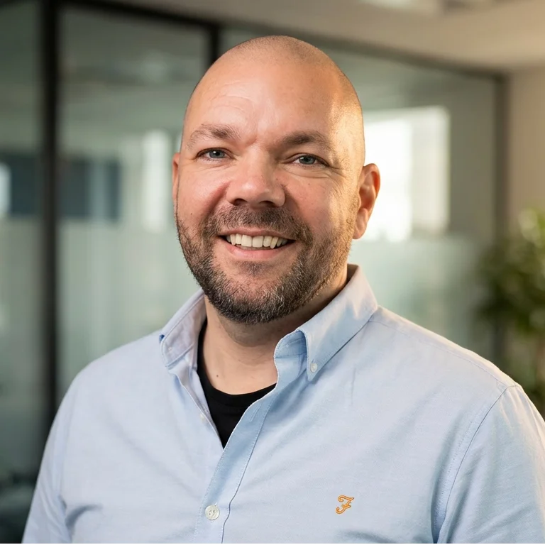 a man standing in front of a purple wall