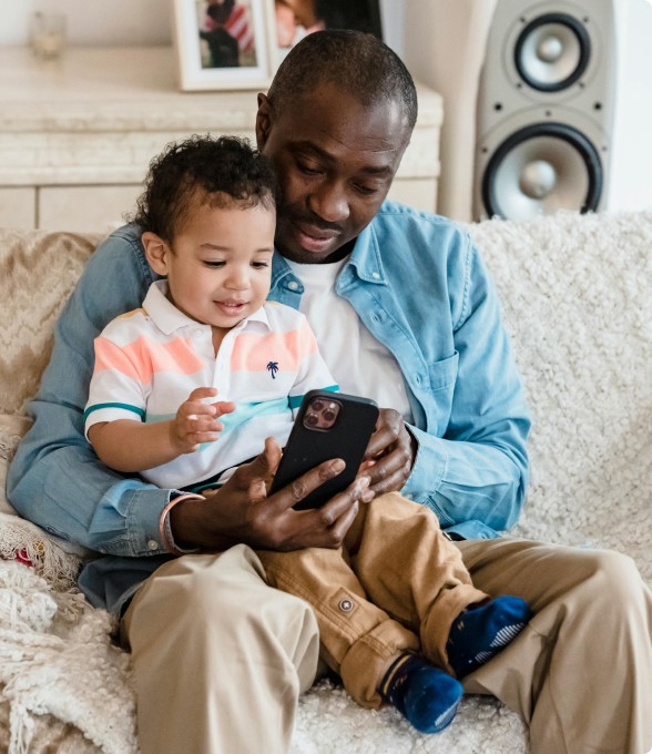 man with child reading