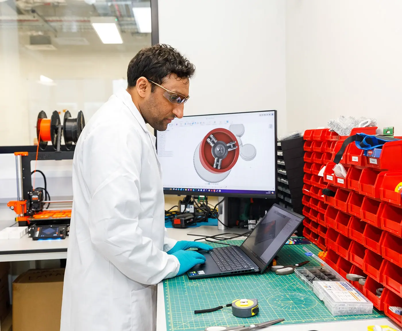 person in lab working on laptop