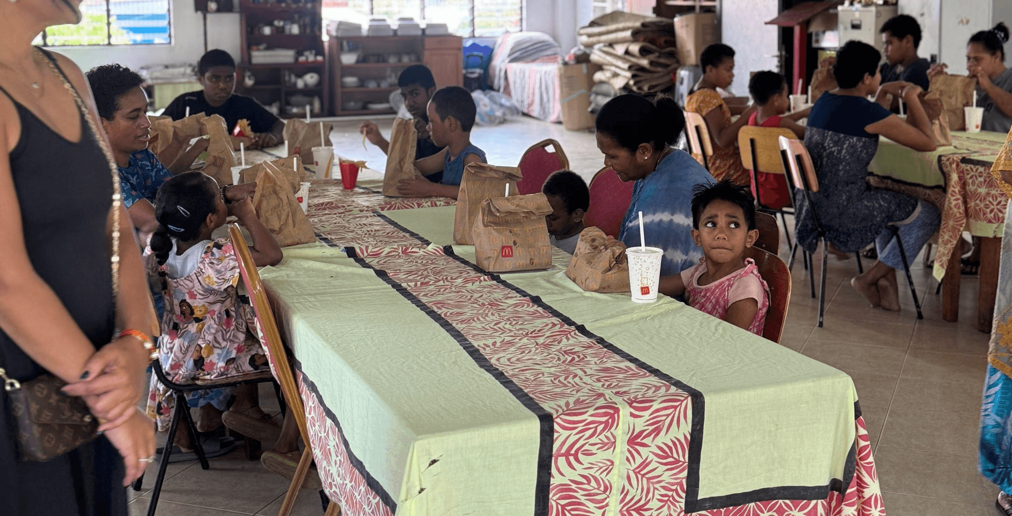 five children smiling while doing peace hand sign