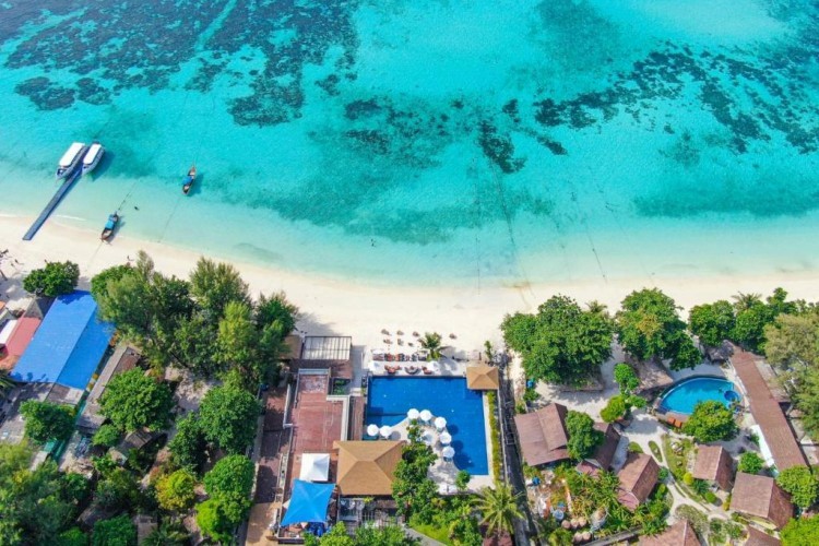 sunloungers fronting buildings near mountain