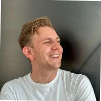 a man with a goatee smiles at the camera