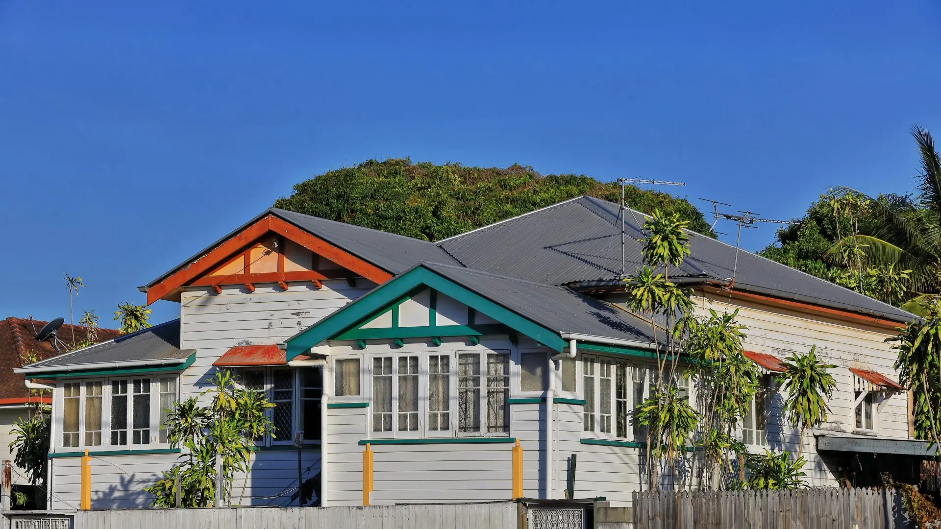 White wooden house with green and orange accents