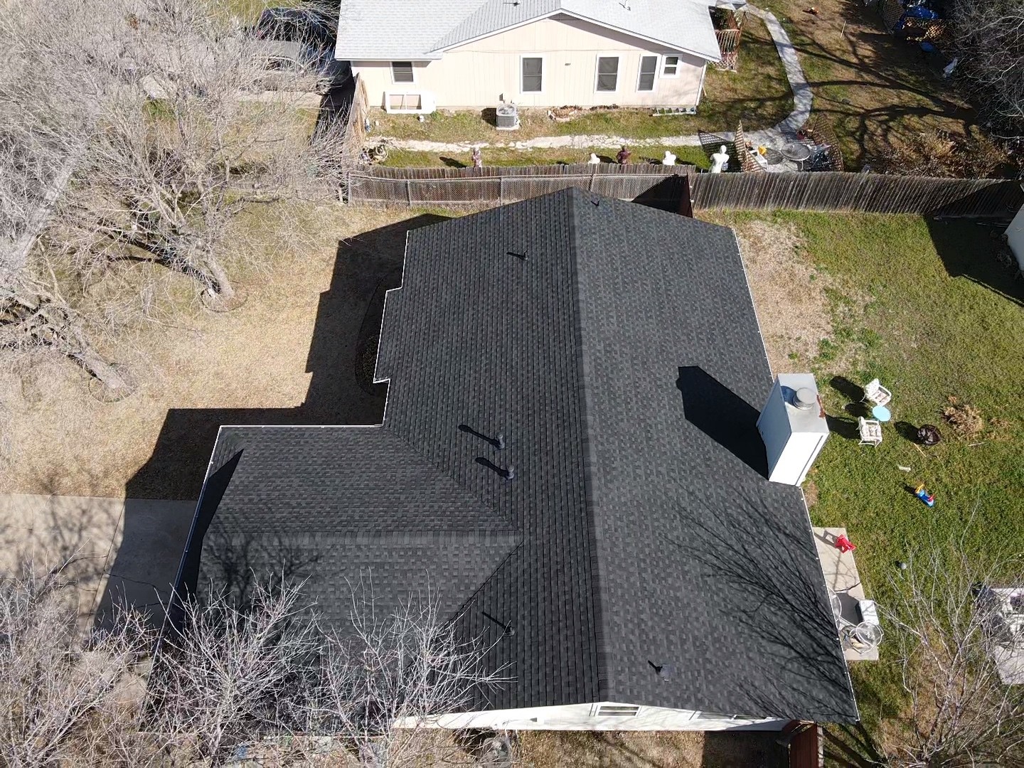 GAF HDZ charcoal-colored crossed hip roof with a chimney offering a sleek, modern look.