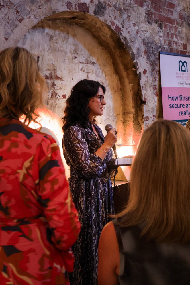 woman faces crowd with a microphone in hand