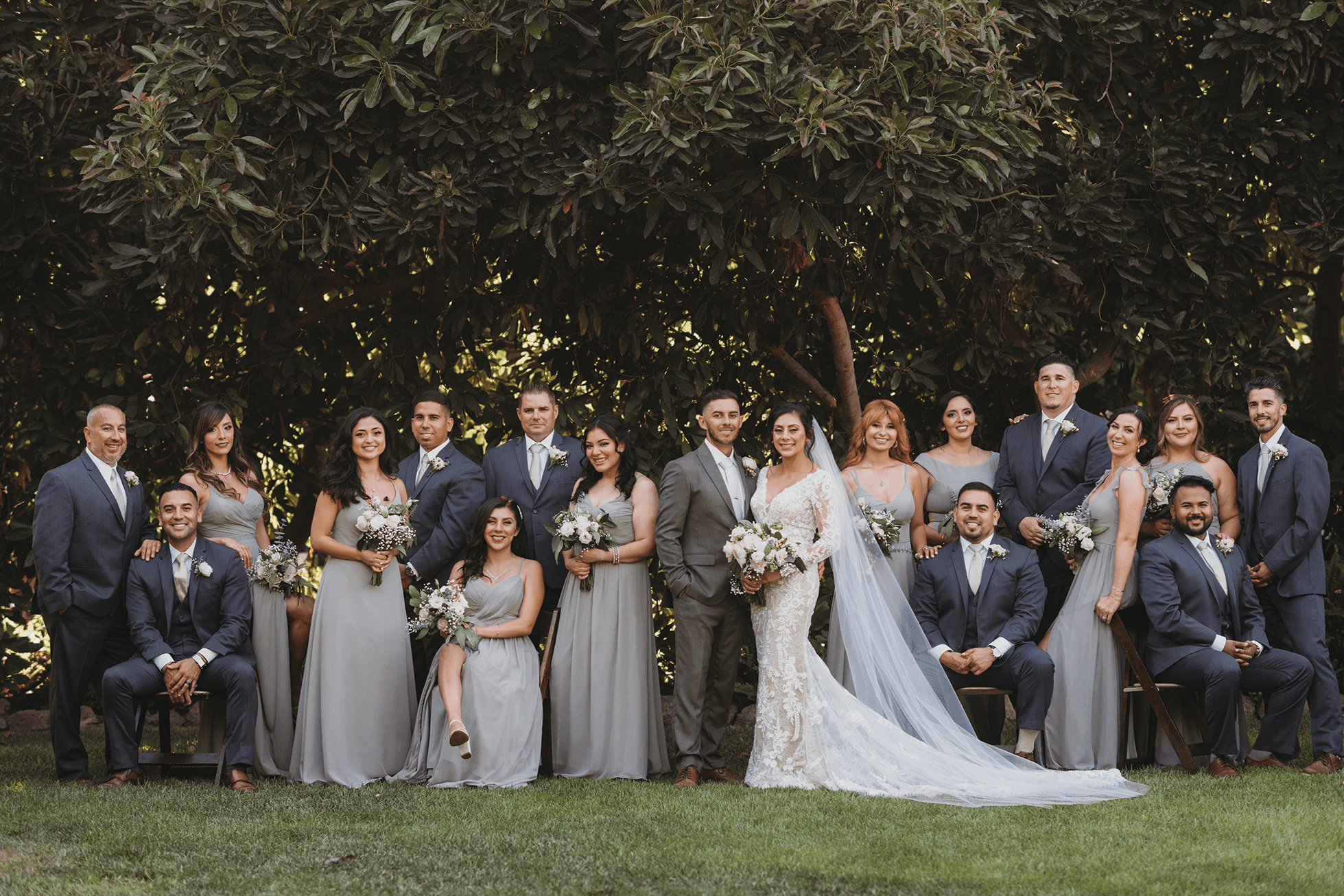Editorial wedding party portrait with seated and standing poses
