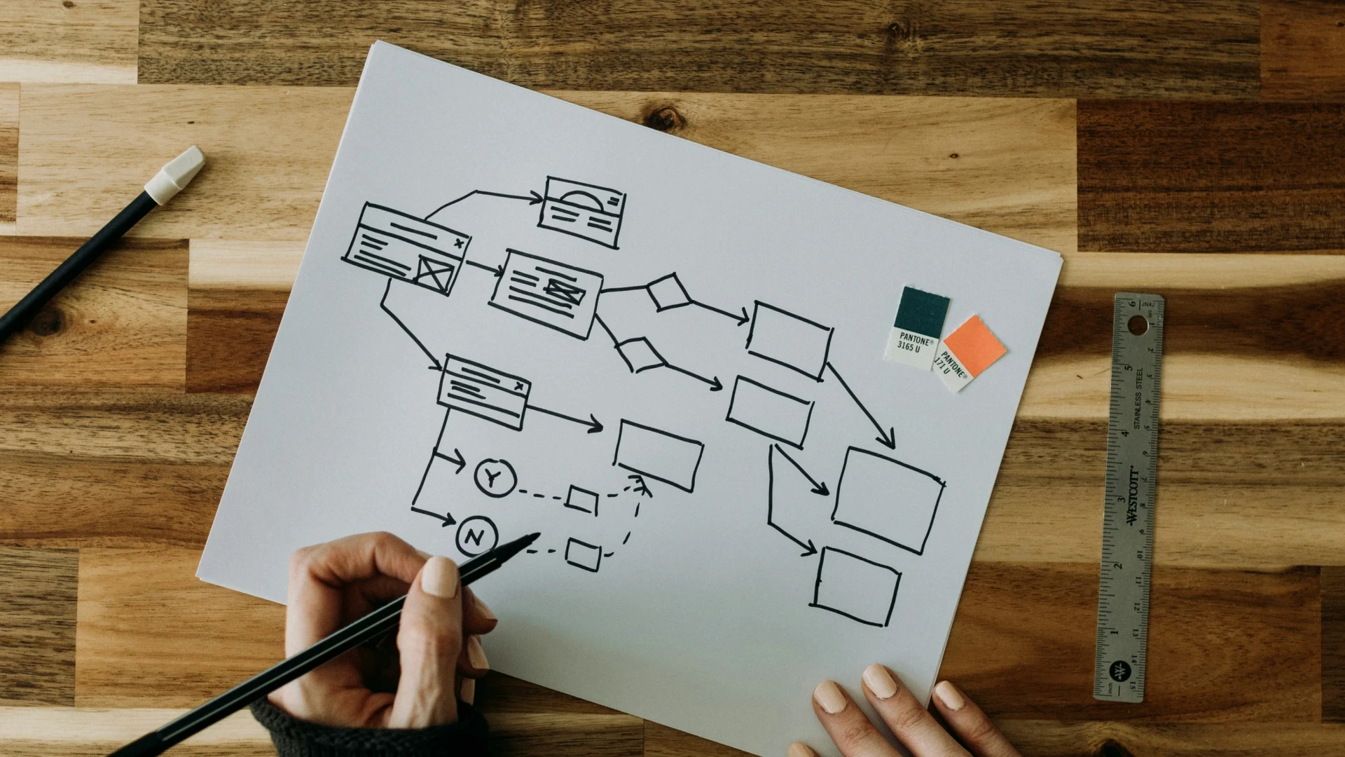 a person drawing a diagram on a piece of paper