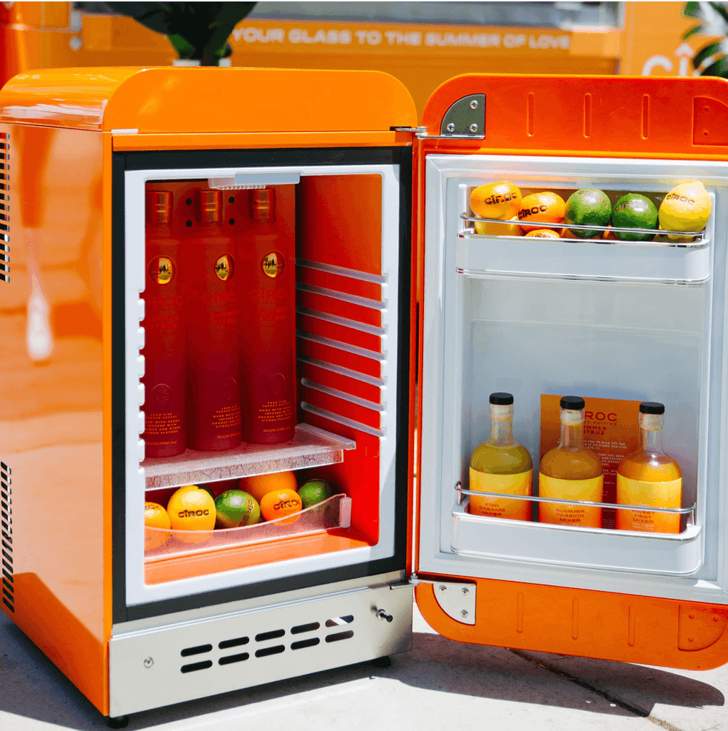 Orange mini fridge featuring cocktails