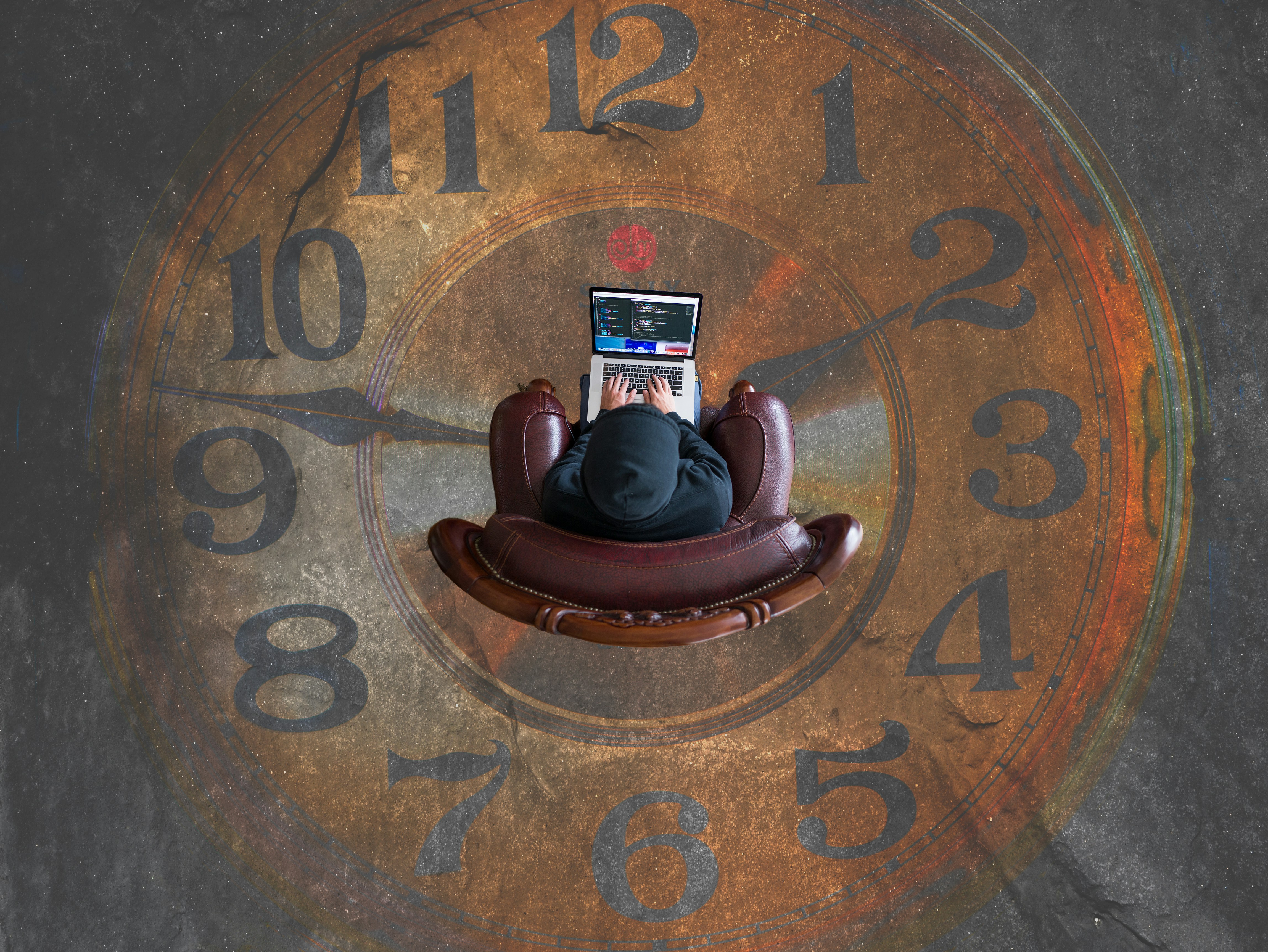 Man sitting on a chair over a clock setting floor