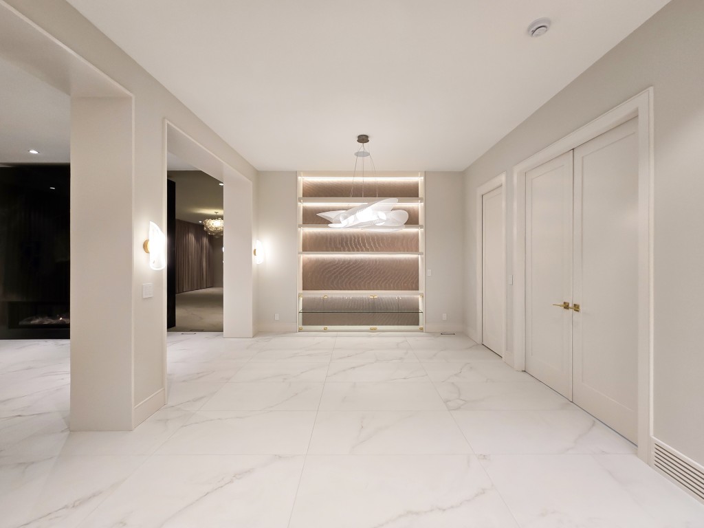 Image of KHD Homes luxurious primary ensuite with marble floors and custom shelving interior design layout.