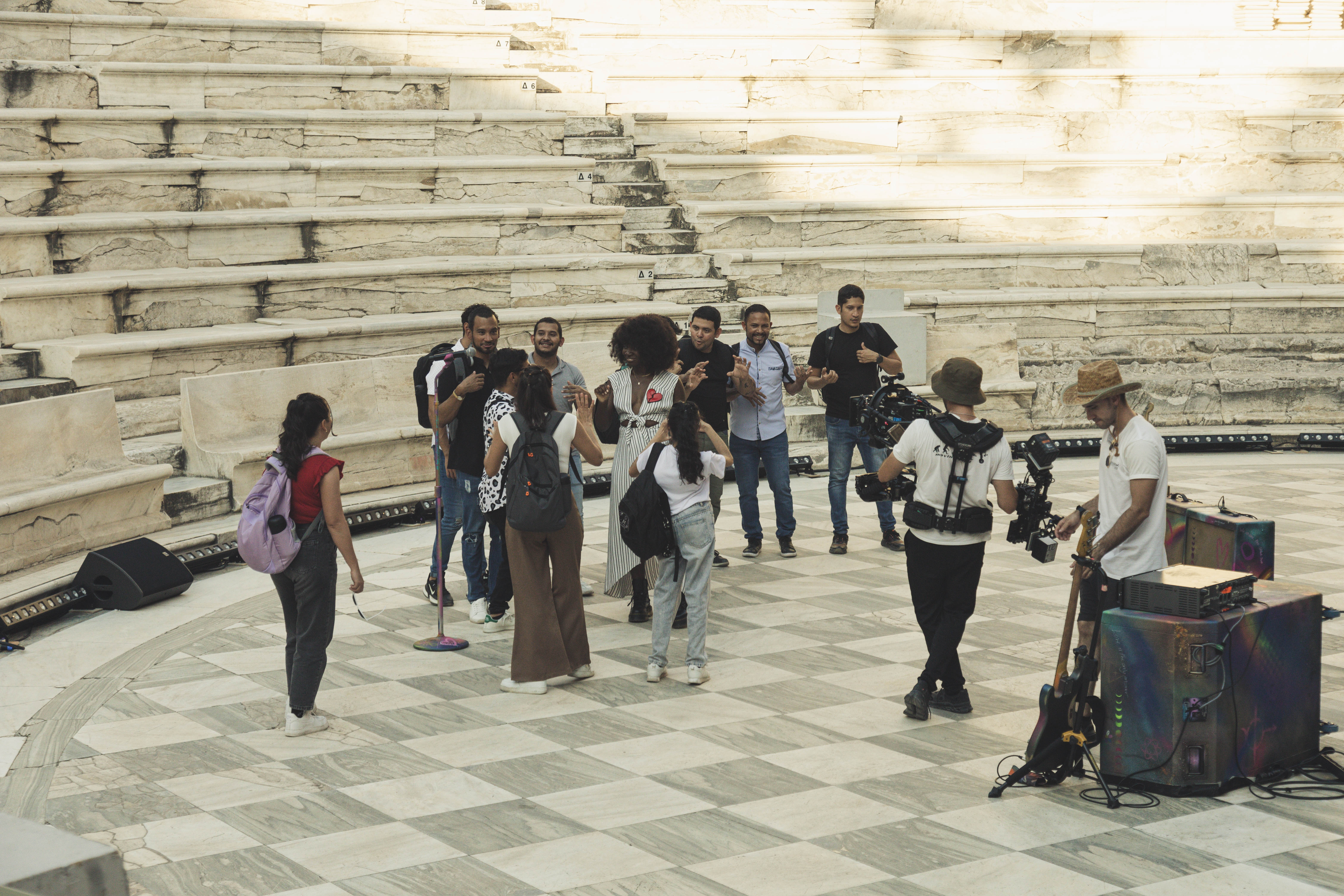 Natasha Ofili (a dark-skinned Black woman) and Coros de Manos Blancas (the Venezuelan White Hands Choir) playing with Coldplay’s instruments on stage.