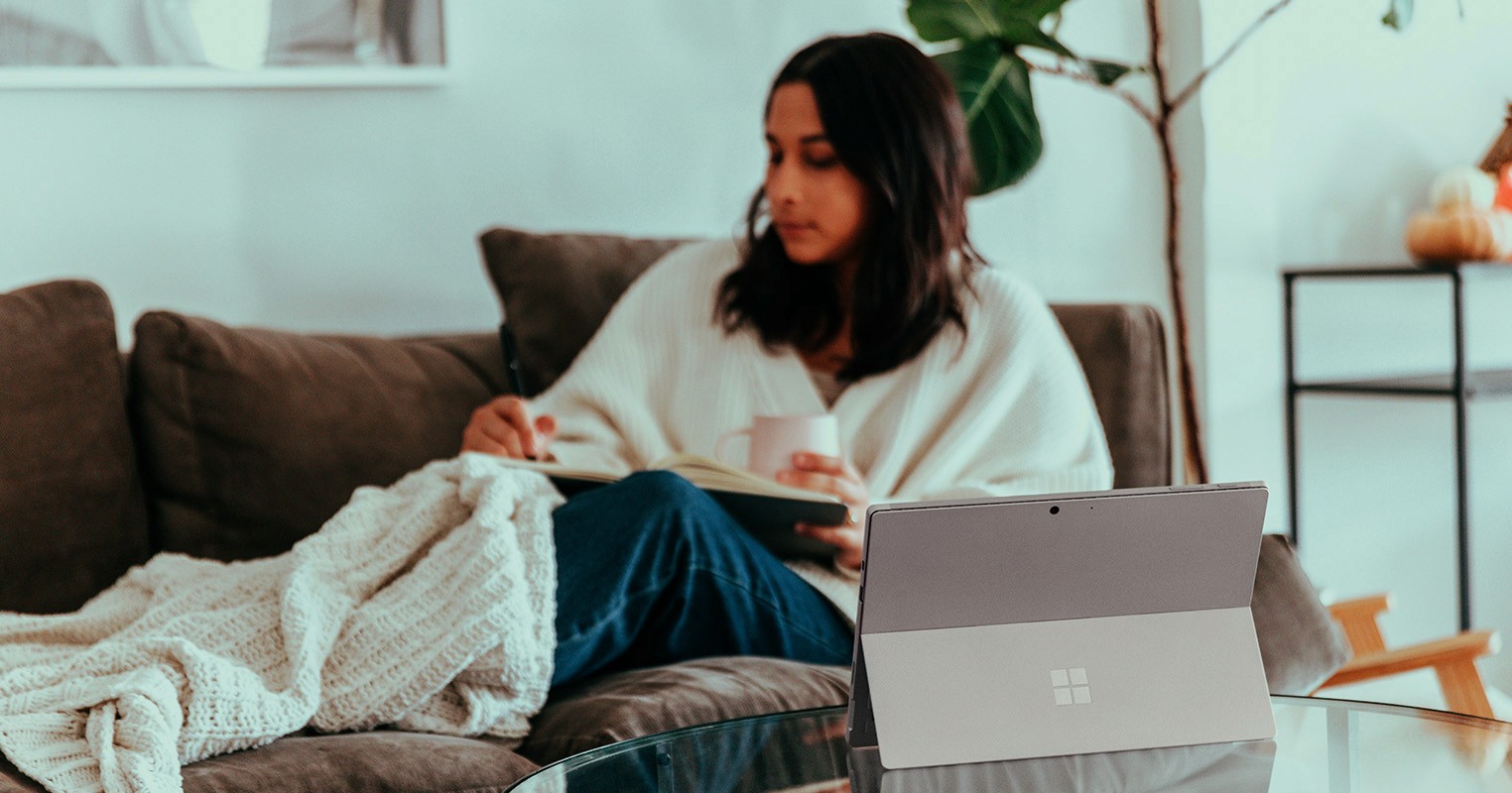 Women working from home on sofa