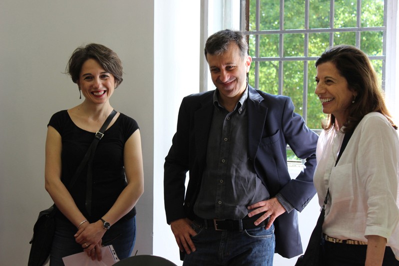 three people in front of a window