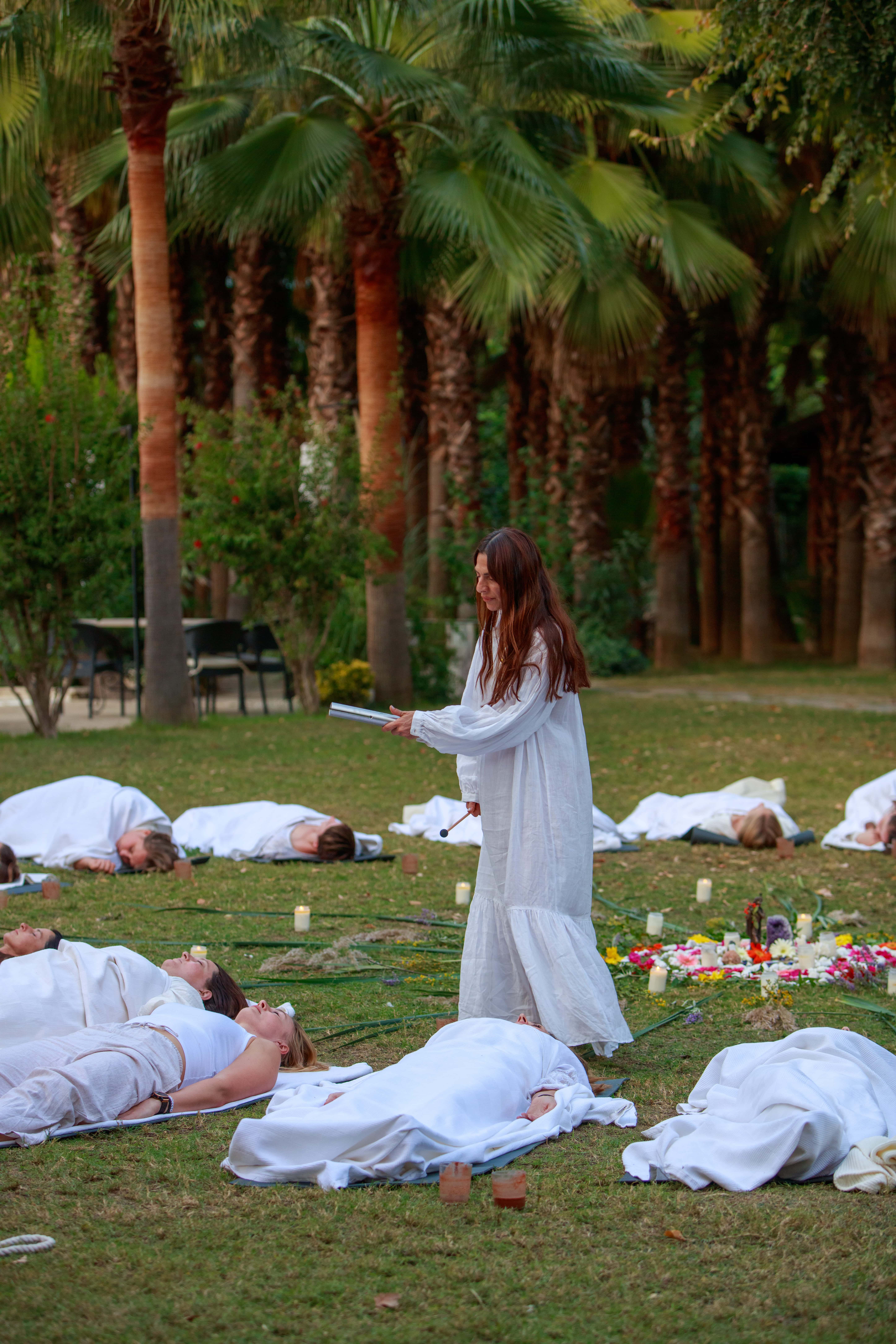 A group of people praticing yoga on the beach in the morning