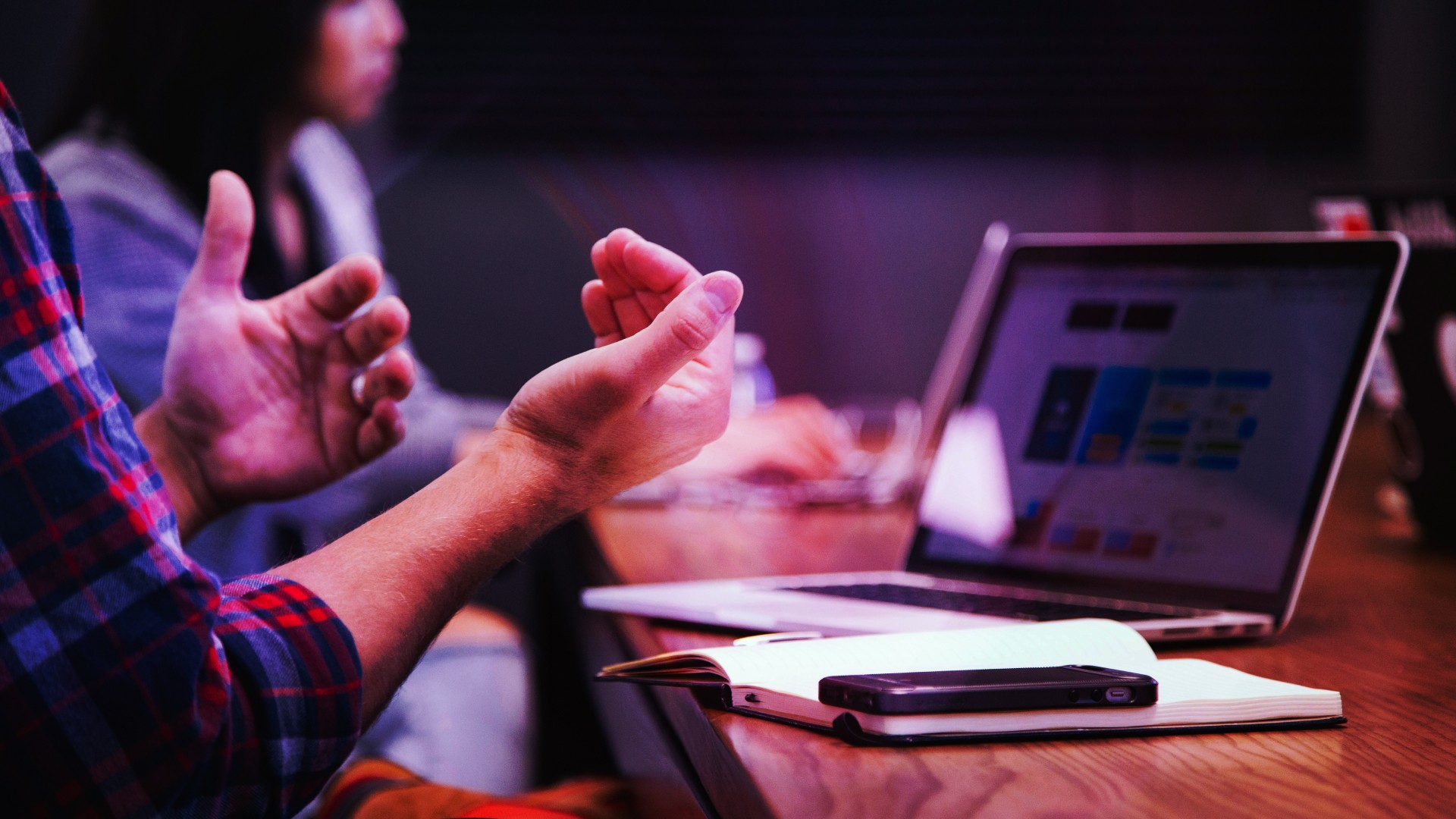 Hands gesturing to emphasise a point while in a meeting