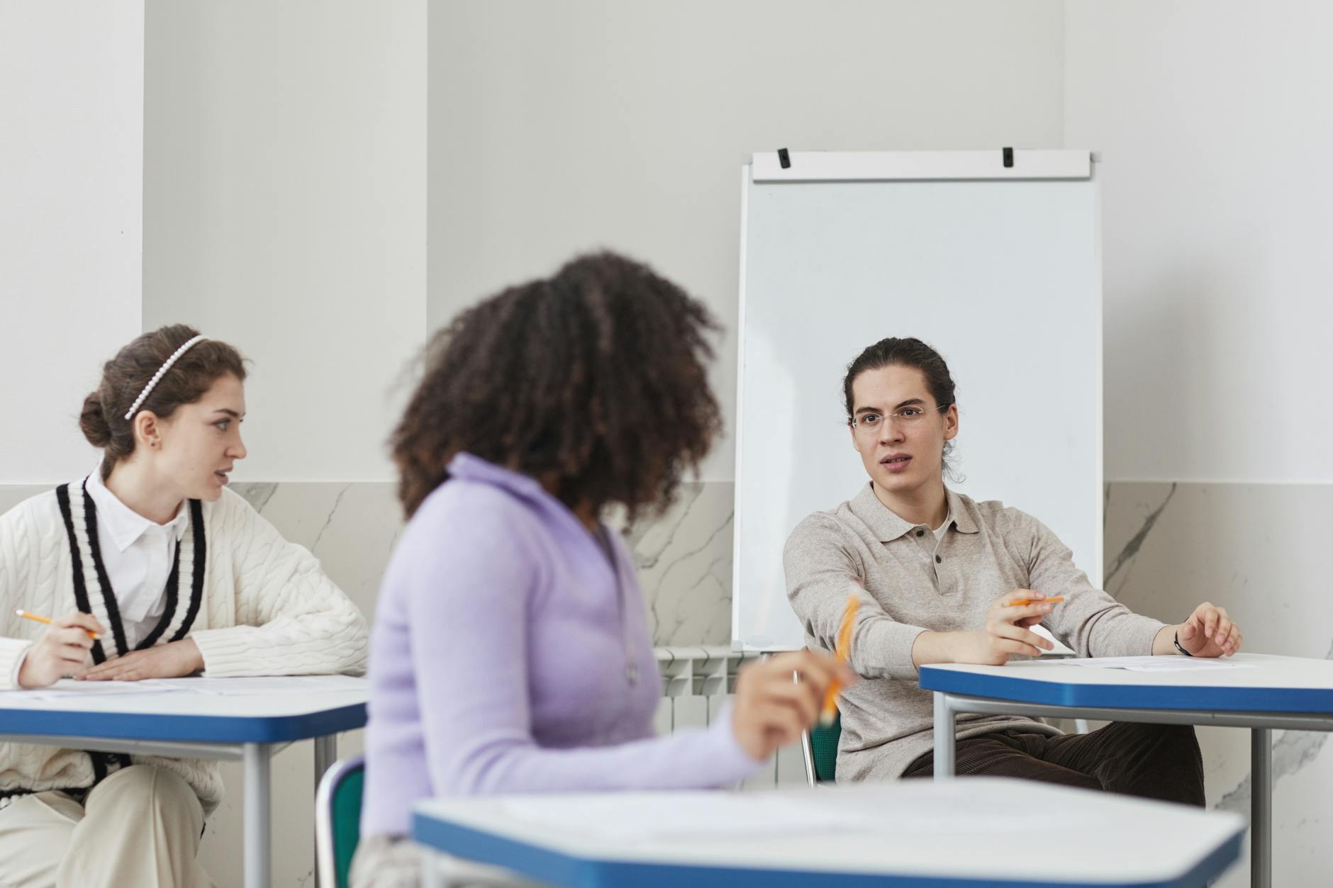 Split view of a teacher leading a lecture versus students working in pairs on a collaborative science project.