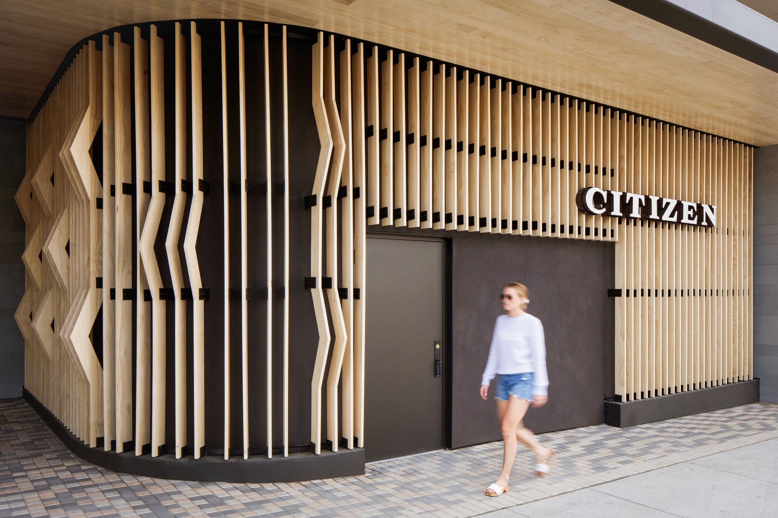 Modern building facade with wood slats and "Citizen" sign